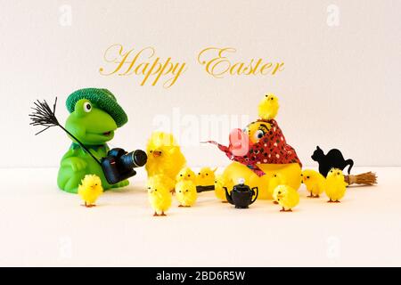 A Happy Easter greeting card with the Easter Duck and Photographer Frog with all their chickens Stock Photo