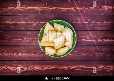 Baursak - traditional Kazakh Asia food national bread in plate on wooden background. Top view Stock Photo