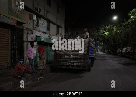 Dhaka, Bangladesh. 07th Apr, 2020. At night, laborers are waiting for unloading flour's bags from a truck in Dhaka, Bangladesh, during the nationwide lockdown of emergency in an attempt to stop the widespread of the coronavirus Covid-19 disease. Credit: ZUMA Press, Inc./Alamy Live News Stock Photo
