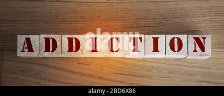 Word Addiction made from wooden letters lies on a wooden background. Detox or intoxication no drugs no drinking concept Stock Photo
