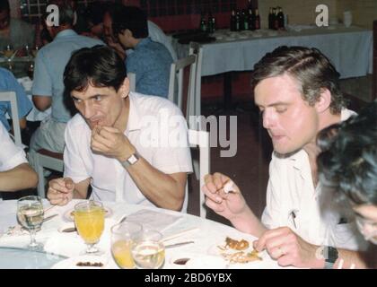 CHINA - 1989: Retro photo shows a group of caucasian - European businessmen and Chinese businessmen have a working lunch. Stock Photo