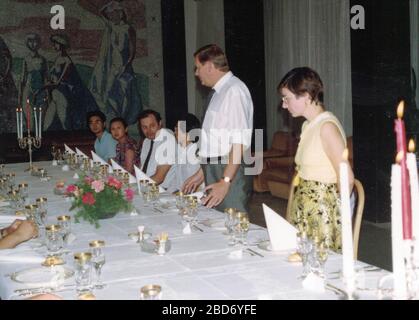 CHINA - 1989: Retro photo shows a group of caucasian - European businessmen and Chinese businessmen have a working lunch. Stock Photo