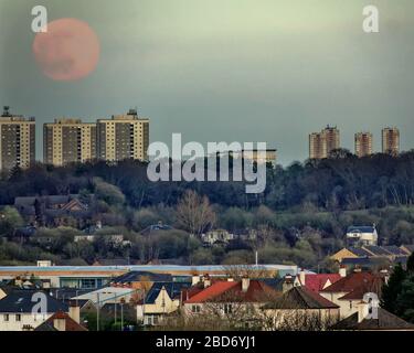 Glasgow, Scotland, UK, 7th April, 2020: UK Weather:  Sunny spring day gave clear sky as the supermoon appeared over the high rises of Maryhill and the hilltop Dawsholm park with the suburb of temple in the foreground . Copywrite Gerard Ferry/ Alamy Live News