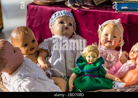 CESENA (FC) - FEBRUARY 17, 2019: lights are enlightening dolls for sale on stalls at antique fair Stock Photo