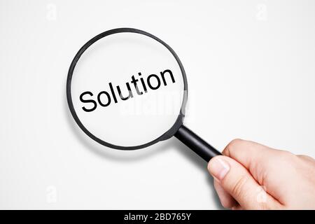female hand holding magnifier, solution search concept Stock Photo