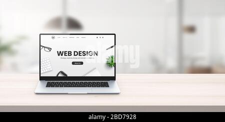 Web design studio promo web site on laptop display on office desk concept Stock Photo