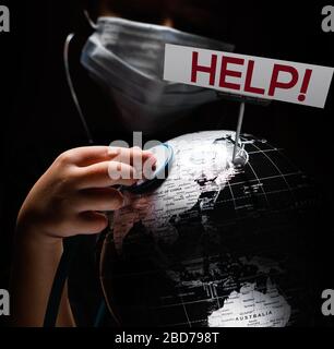 Kid hold globe put stethoscope on sphere where shown billboard Help red letters face covered in mask on black background. Pandemic outbreak Covid 19, Stock Photo