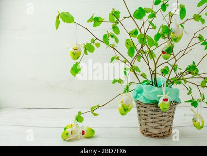 Green tree branch with Easter eggs Stock Photo