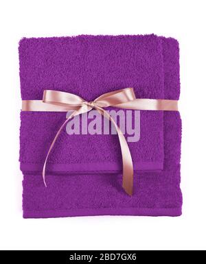 Two rolled and folded terry towels tied by ribbon isolated. Stack terry towels against a white background. Gift towels. Stock Photo