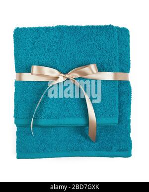 Two rolled and folded terry towels tied by ribbon isolated. Stack terry towels against a white background. Gift towels. Stock Photo
