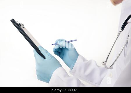 Doctor in blue latex gloves holding medical clipboard with empty blank sheet of paper. Concept of healthcare and medicine. Empty clipboard template Stock Photo