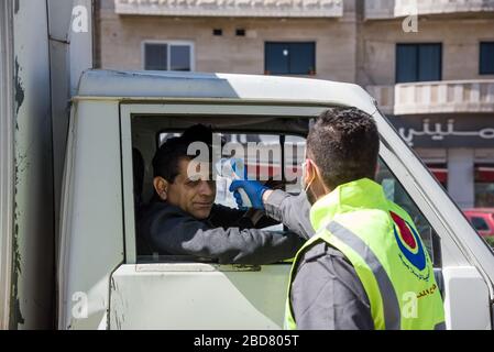 Baalbek, Lebanon, 7 April 2020. Civil Defence staff run a fever check on all people in vehicles in an effort to contain novel coronavirus and prevent spread to vulnerable areas. Temperatures of 38.5 celcius or more are taken to the closest hospital for testing. Elizabeth Fitt Credit: Elizabeth Fitt/Alamy Live News Stock Photo