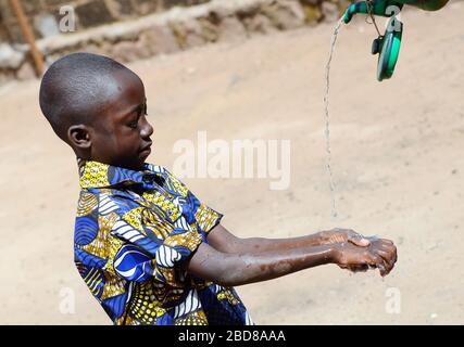 African Boy Washing Hands Properly to Avoid Contamination with Coronavirus or Virus or Bacteria Stock Photo