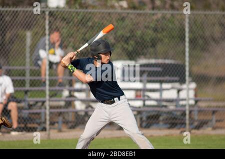Teen baseball player ready to swing in the batters box Stock Photo