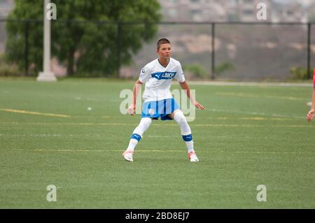 Teen soccer defender in the ready position during a game Stock Photo