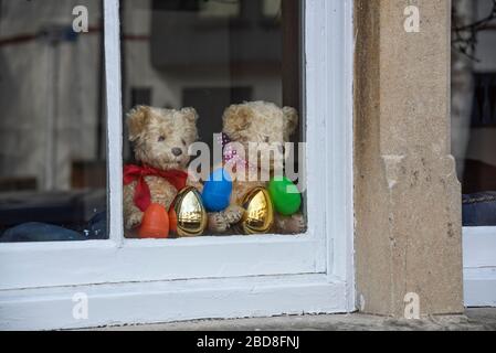 Teddy bears and Easter eggs in a window during the coronavirus (Covid-19) outbreak, April 2020 Stock Photo