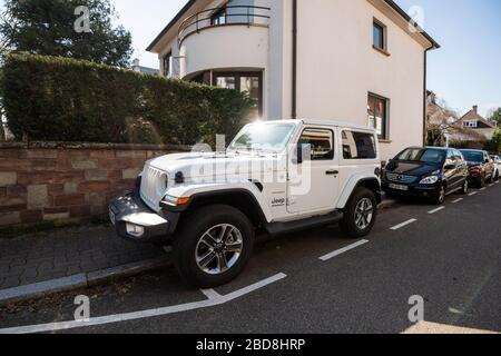 Strasbourg, France - March 18, 2020: Empty French street during Coronavirus Covid-19 pandemic outbreak with new Jeep Sahara Wrangler SUV car parked Stock Photo
