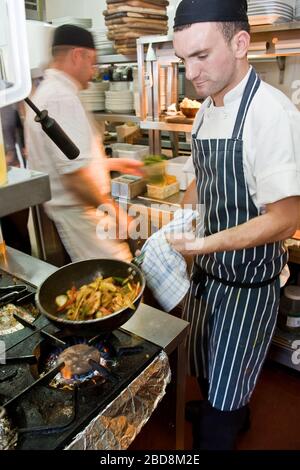 chefs working at commercial kitchen in the UK Stock Photo
