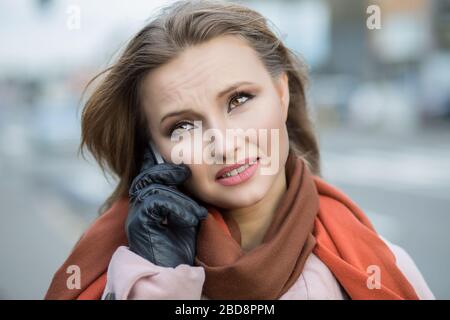 Bad news. Sad woman on phone. Closeup portrait headshot of beautiful upset unhappy, serious girl student talking on mobile cityscape outdoor backgroun Stock Photo