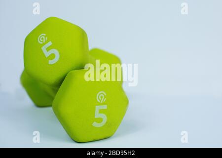 2 Neon Green 5lb Weights on White Background Stock Photo