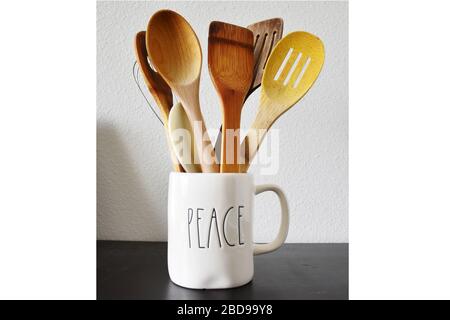 Kitchen spatulas in a cup isolated white background wooden Stock Photo