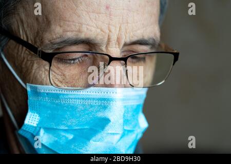 Portrait of an elderly man in glasses and a medical mask Stock Photo
