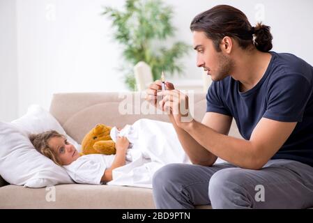 The father taking care of his ill daughter Stock Photo