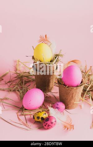 Happy easter concept. large small eggs of various fashionable colors lie in a heap on a pink background. Copy space Stock Photo