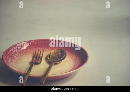 Empty plate at a closed restaurant shows the loneliness, economic crisis, hunger and depression as a result of social distancing, lock down and self i Stock Photo