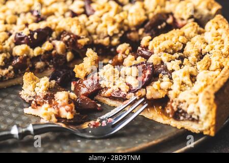 Sweet plum pie. Cut pie on plate. Stock Photo