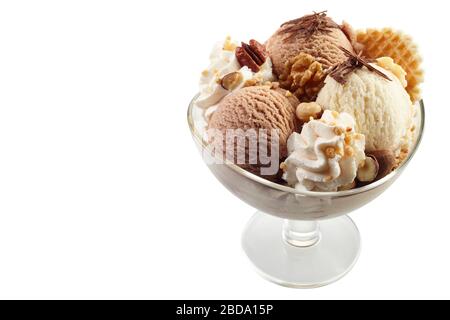 Chocolate and vanilla ice cream with mixed nuts, wafer and chocolate flakes served in a glass dish high angle on white with copy space Stock Photo