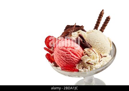 Serving of strawberry and vanilla ice-cream with fresh berries and chocolate flakes in a glass dish isolated on white with copy space Stock Photo