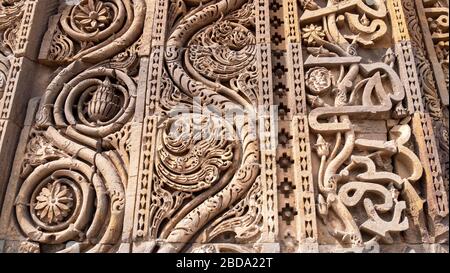 close up of carved inscription in arabic set in a sandstone wall at qutub minar complex in new delhi Stock Photo
