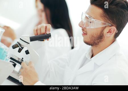 close up.man scientist looking through a microscope Stock Photo