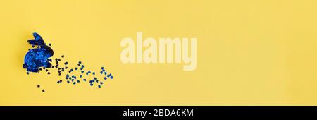 Banner with rabbit bunny shaped form for gingerbread decorated with blue sparkles inside on yellow background with copy space. Easter concept Stock Photo