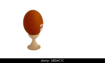 Egg standing on cup, on a soft white background Stock Photo