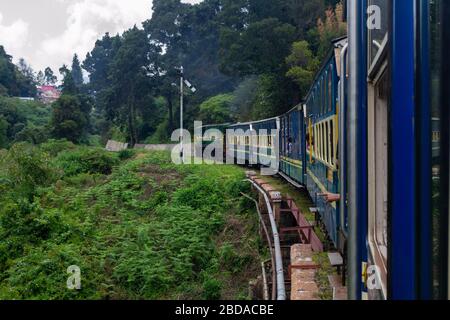 Beautiful view of the green landscape and the Golden Rock YDM4 Diesel Engine going over a bridge with the Nilgiri Mountain Railway Train, Tamil Nadu Stock Photo