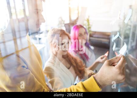 Group of multi ethnic executives discussing during a meeting. Business man and woman sitting around table at office and smiling. A team of young Stock Photo