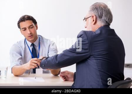 Old businessman meeting with advocate in pretrial detention Stock Photo