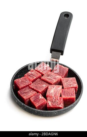 Cubes  of raw beef meat on small frying pan isolated on white Stock Photo