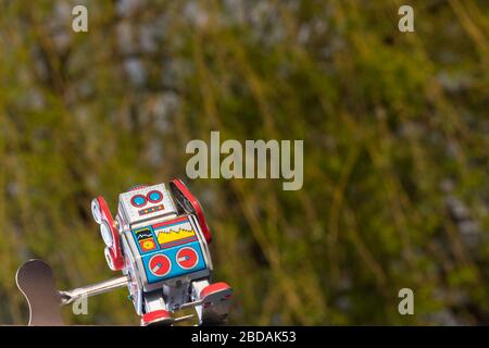 Vintage toy robot with sky behind. Artificial intelligence concept. Stock Photo
