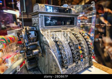 Ornate silver antique cash register with selective focus in a sweet candy shop Stock Photo