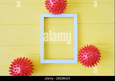 Abstract red balls virus strain model with wooden frame on yellow background. Respiratory syndrome coronavirus and Novel coronavirus covid-19 with Stock Photo