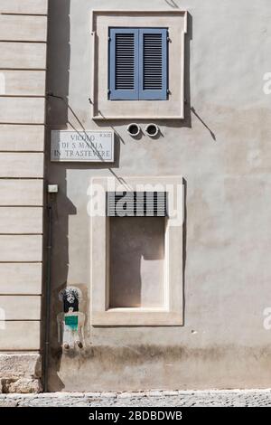 Street view of boarded and shuttered windows on an old building in Trastevere, Rome, Italy. Stock Photo
