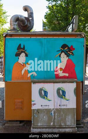 A mural of two Geisha on the side of an outdoor food kiosk in Amsterdam, Netherlands. Stock Photo