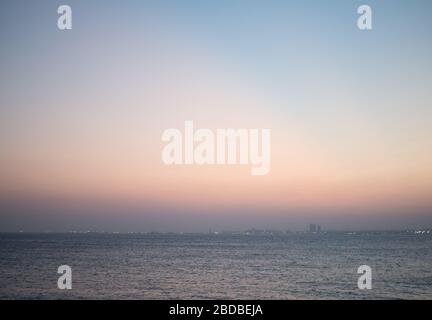 Simple bokeh background with misty sky in the evening and waves in the sea Stock Photo