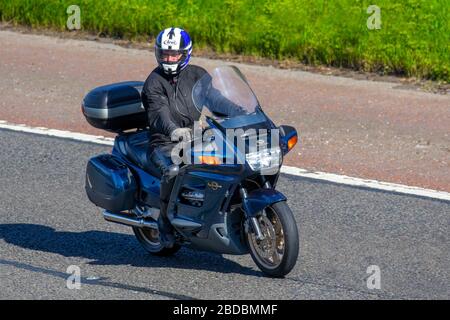 Blue Honda Pan European Motorbike rider; two wheeled transport, motorcycles, vehicle, roads, motorbikes, bike riders motoring on the M6 motorway Chorley, UK Stock Photo
