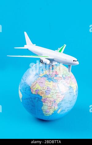 Plastic toy plane on the globe. Flight travel concept. Travel by airplane. Takeoff and landing of the aircraft. Return home from flight. empty Copy Stock Photo