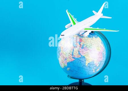 Plastic toy plane on the globe. Flight travel concept. Travel by airplane. Takeoff and landing of the aircraft. Return home from flight. empty Copy Stock Photo