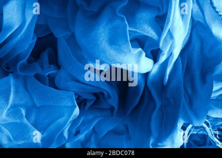 Texture of classic blue Wrinkled Fabric. Trendy color of clothes. Close-up. Stock Photo
